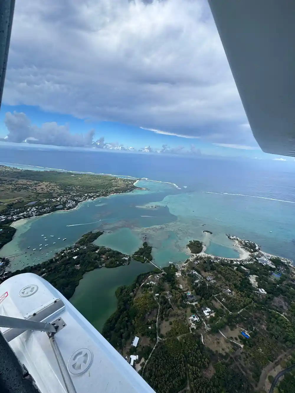 Over the aircraft tail towards a wooded point and lagoon