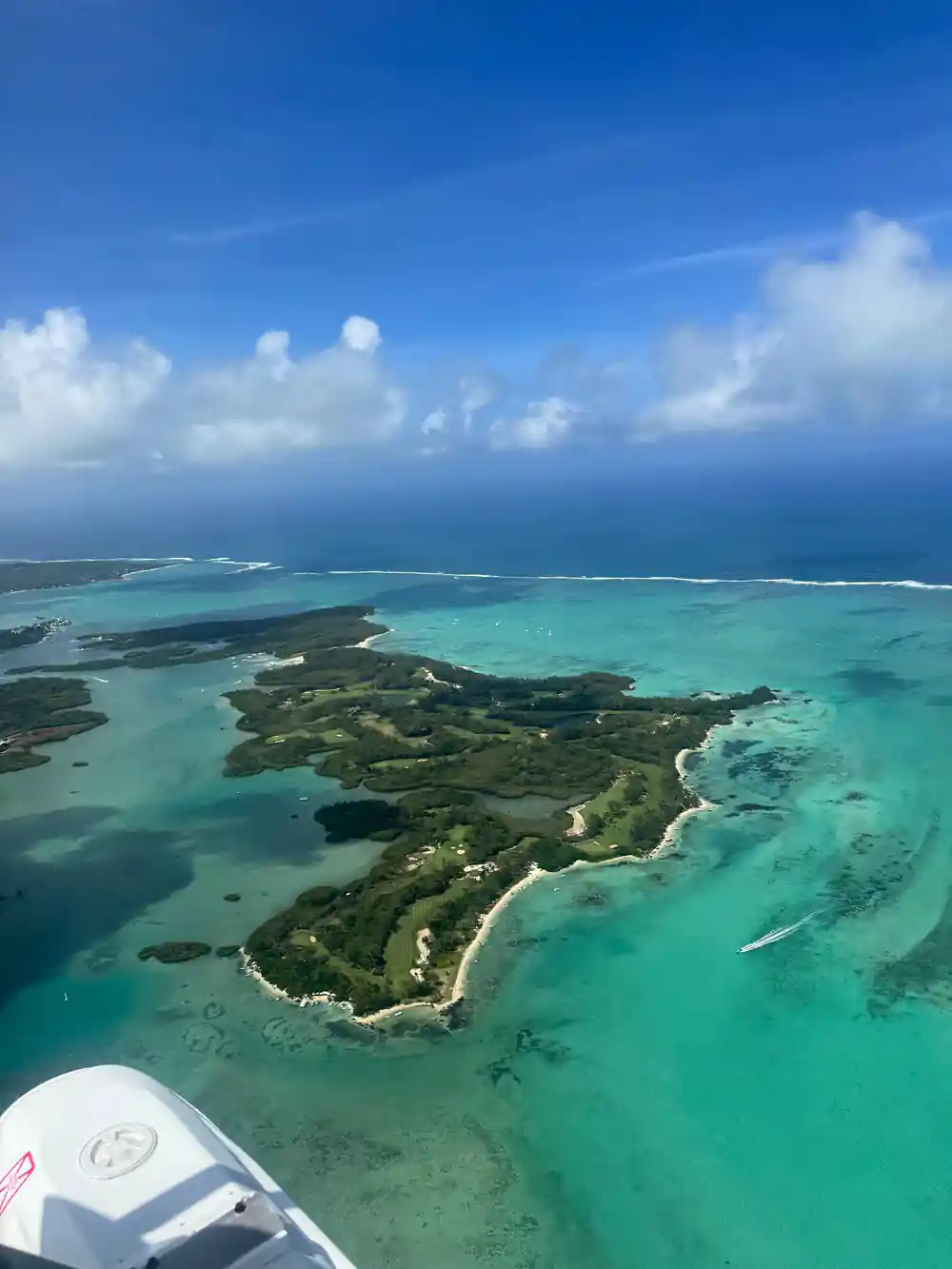 A green island threaded with lagoon channels and reef