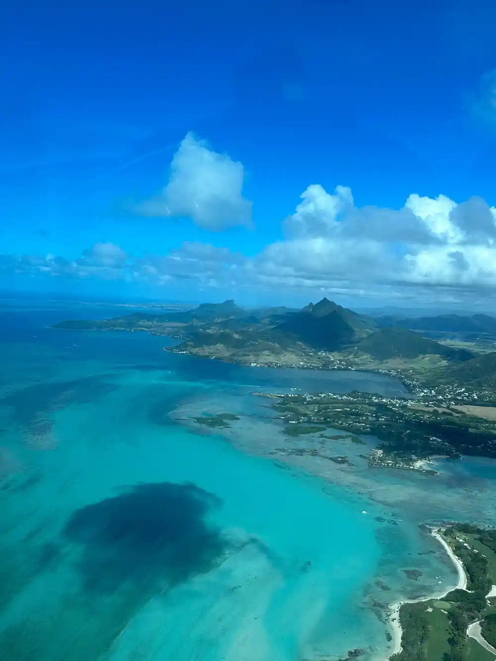 A mountain peak standing behind a lagoon coastline