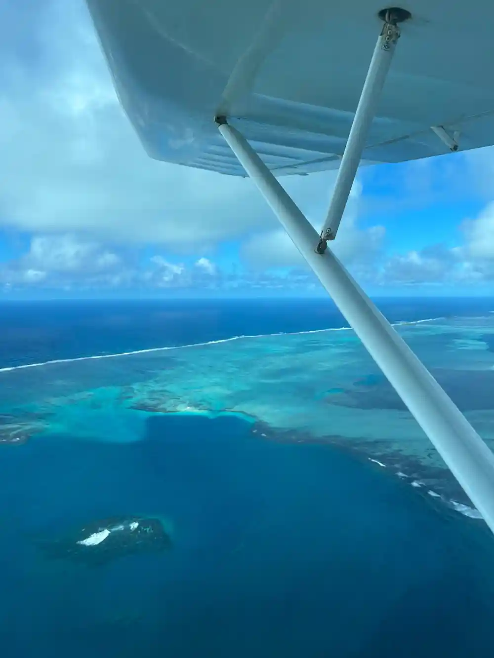 Past the wing to blue water and a submerged reef