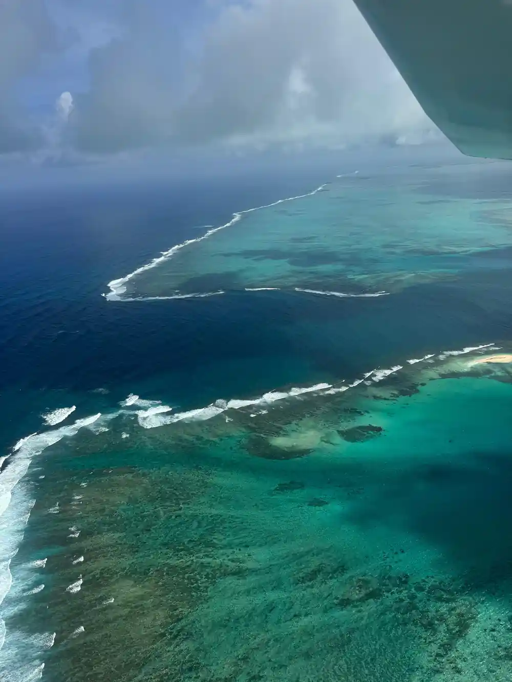 The reef edge with white surf against deep blue