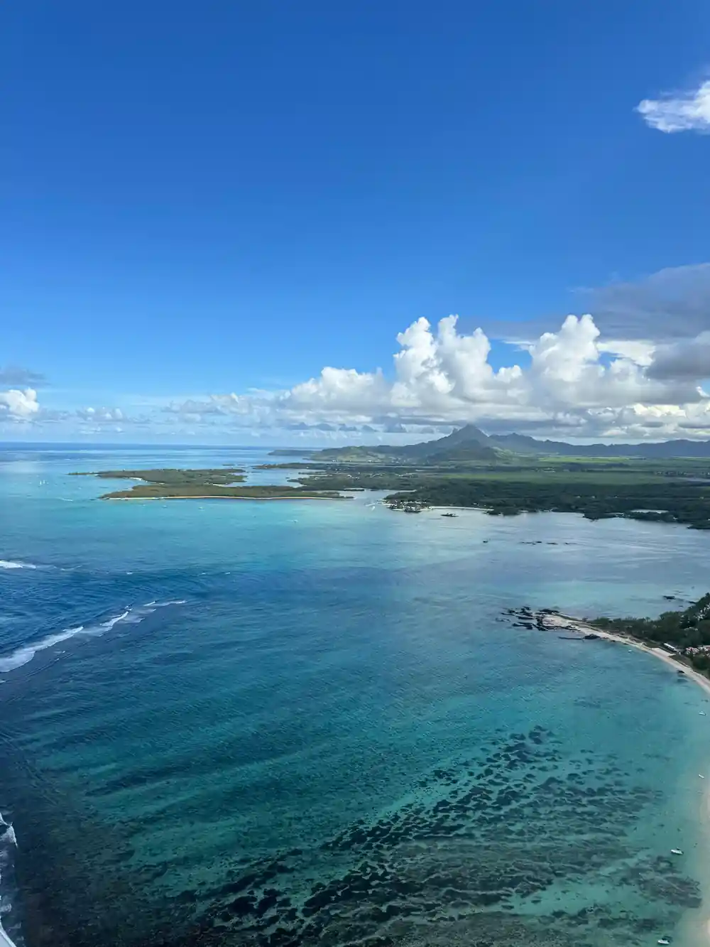 Reef and headland with mountains on the horizon