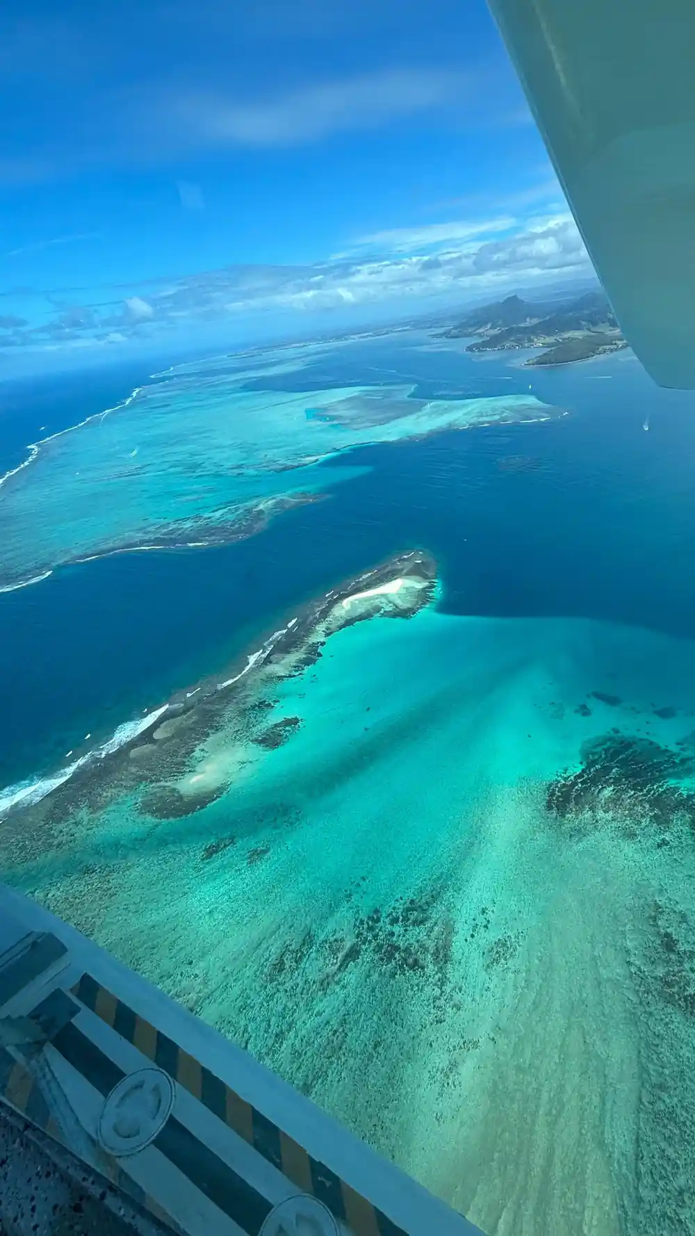 A sandbank island with a pale beach and turquoise shelves